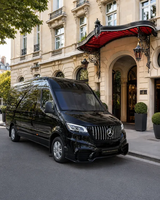 Black Mercedes Sprinter outside a Paris hotel entrance