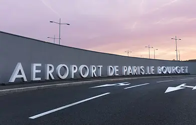 Paris-Le Bourget Airport entrance sign at dusk.