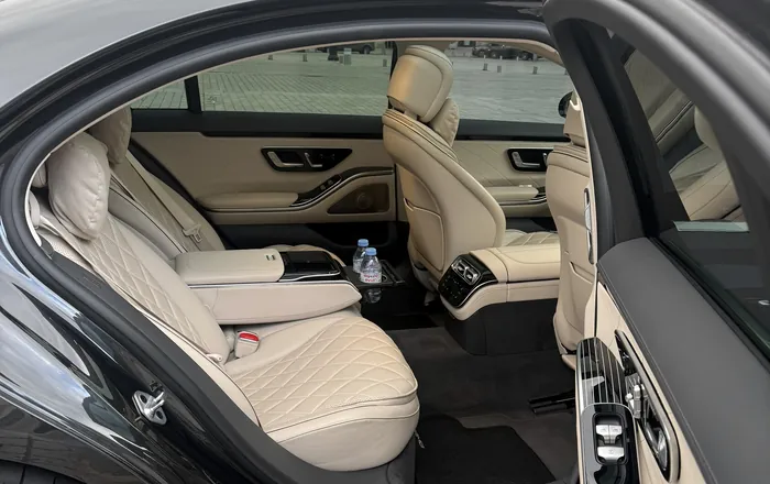 Black Mercedes S-Class with its rear door open onto an ivory leather cabin, Place Vendôme