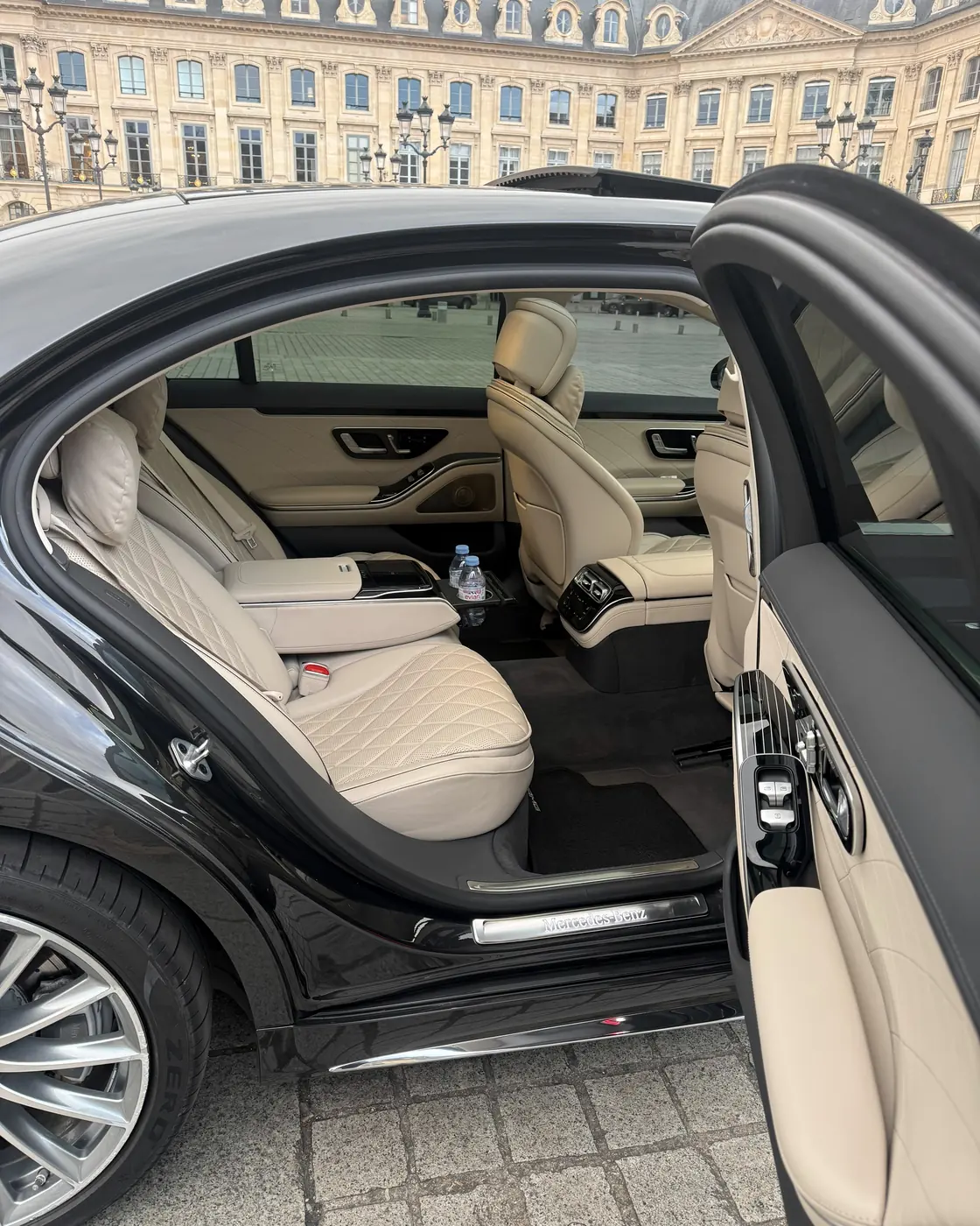 Rear door of a Mercedes S-Class held open on Place Vendôme